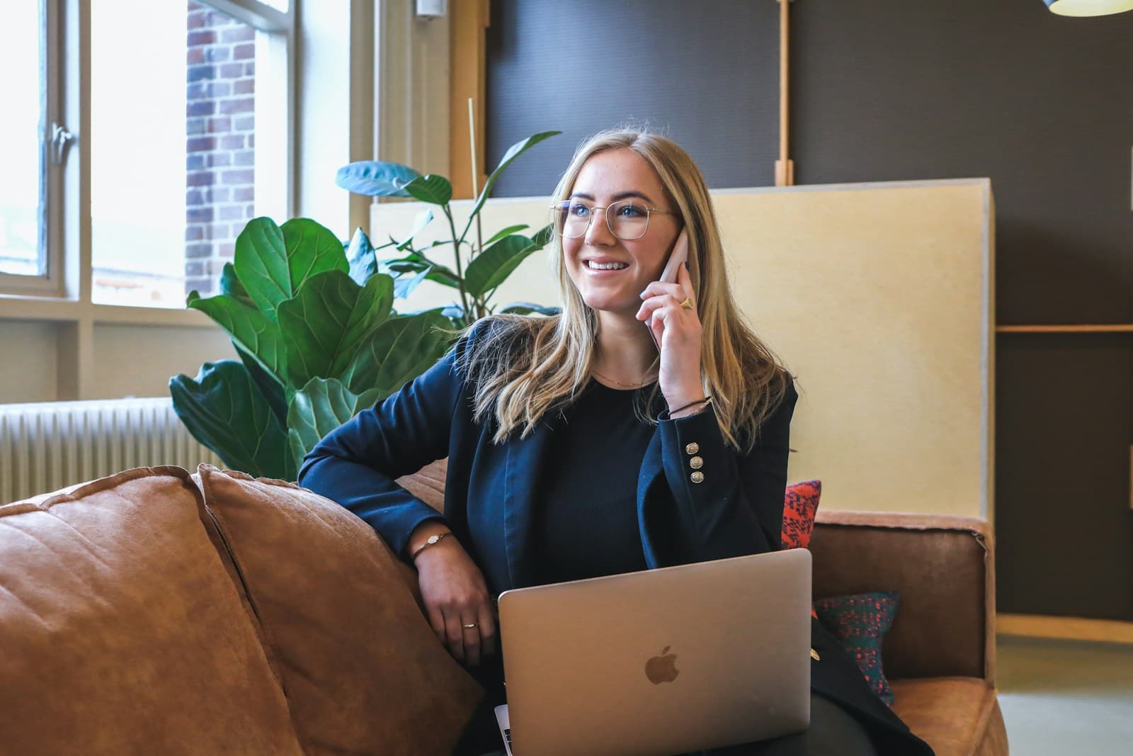 Confident businesswoman working on a laptop in a bright professional setting (Photo: Unsplash)